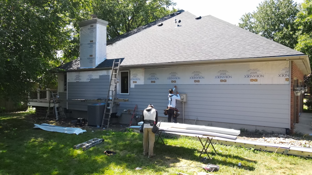 First fruits workers doing siding work