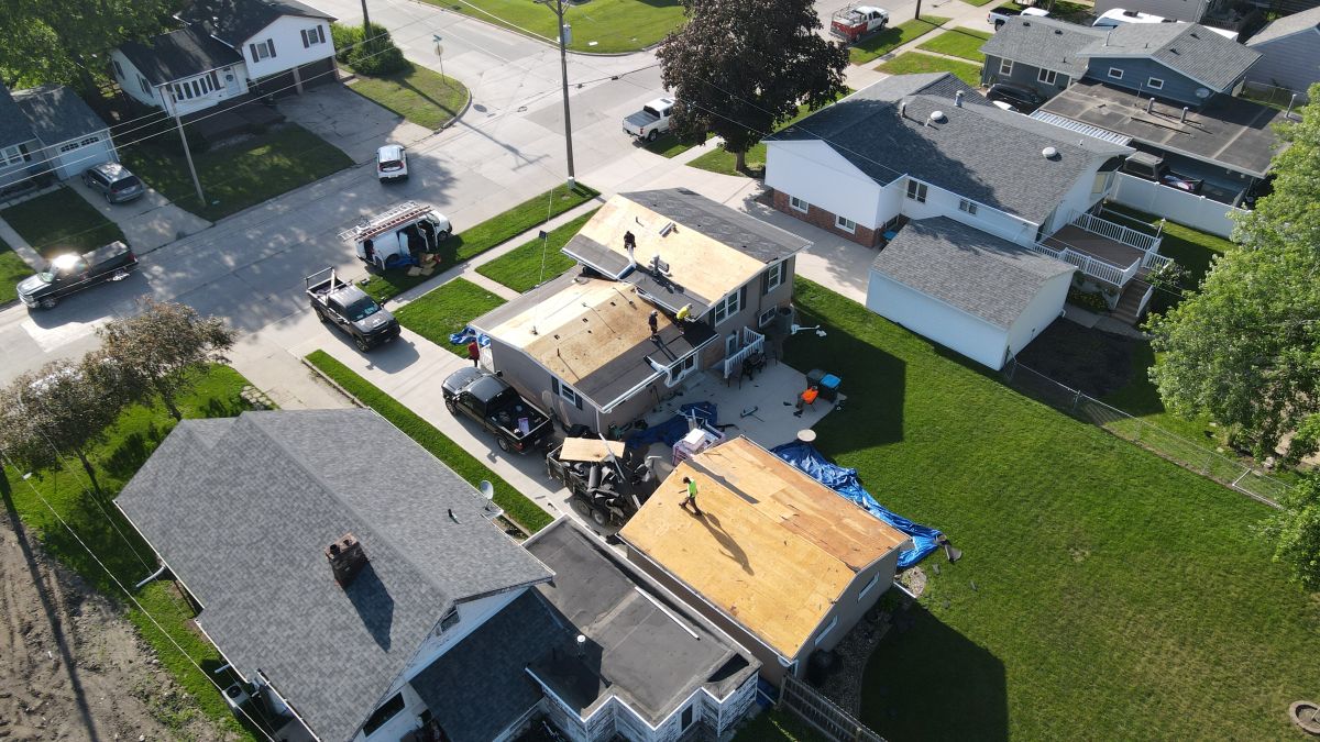Aerial view of a roof being replaced and getting new shingles